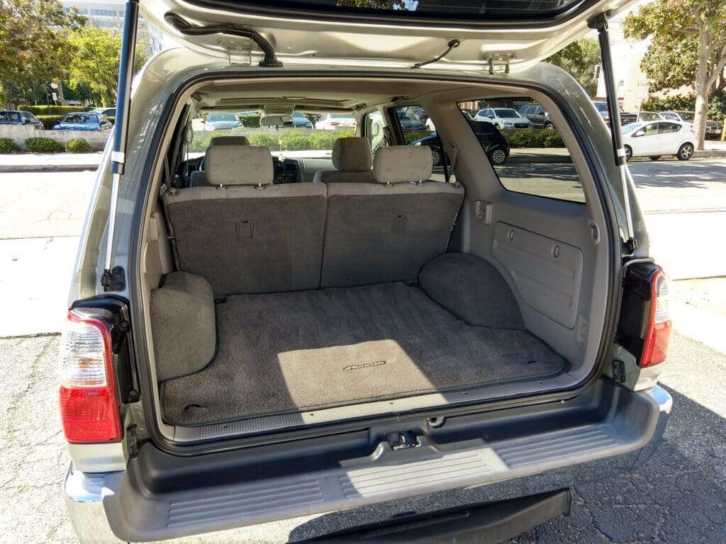 Open SUV trunk showing spacious, clean cargo area with rear seats.