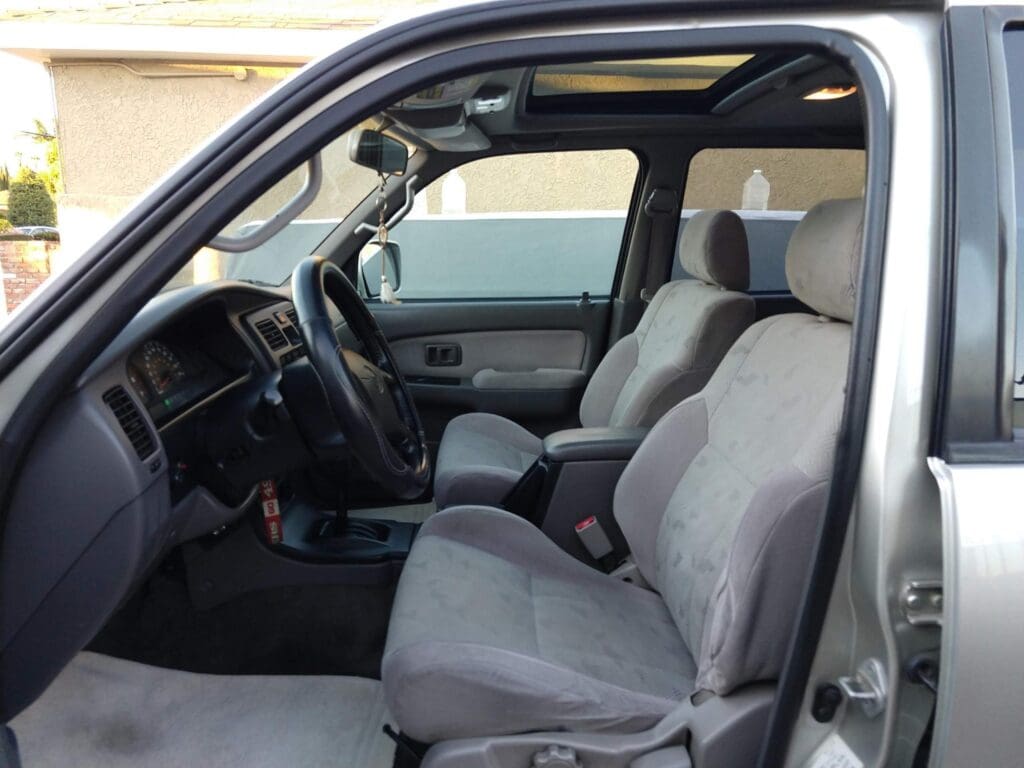 Interior of a vehicle showing front seats and dashboard.