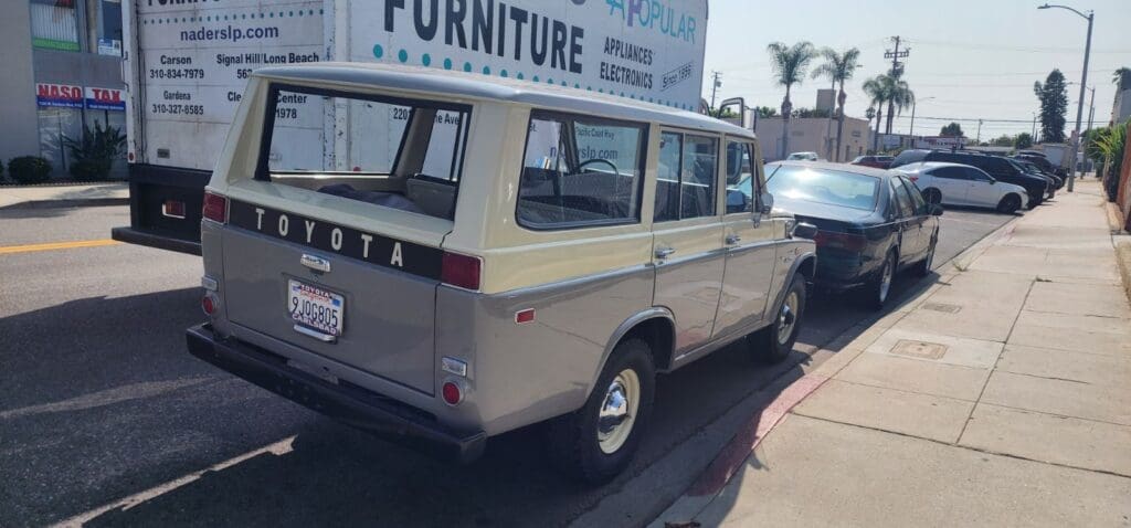 Classic beige Toyota Land Cruiser parked on a sunny street.