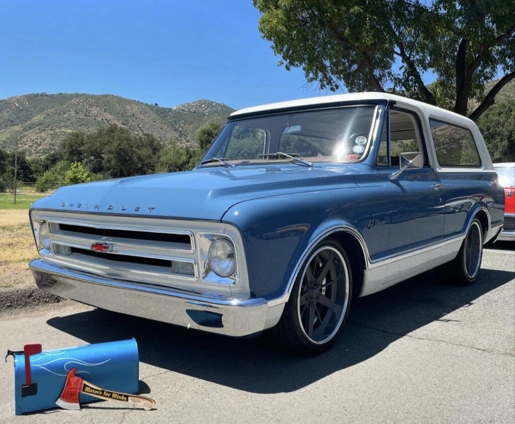 Classic blue and white Chevrolet truck parked outdoors on a sunny day.