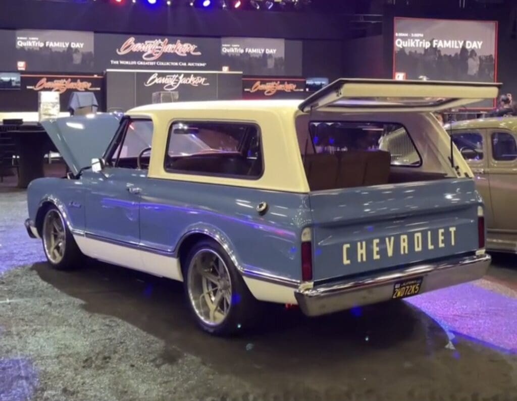 Classic Chevrolet SUV with blue and cream two-tone paint at a car show.