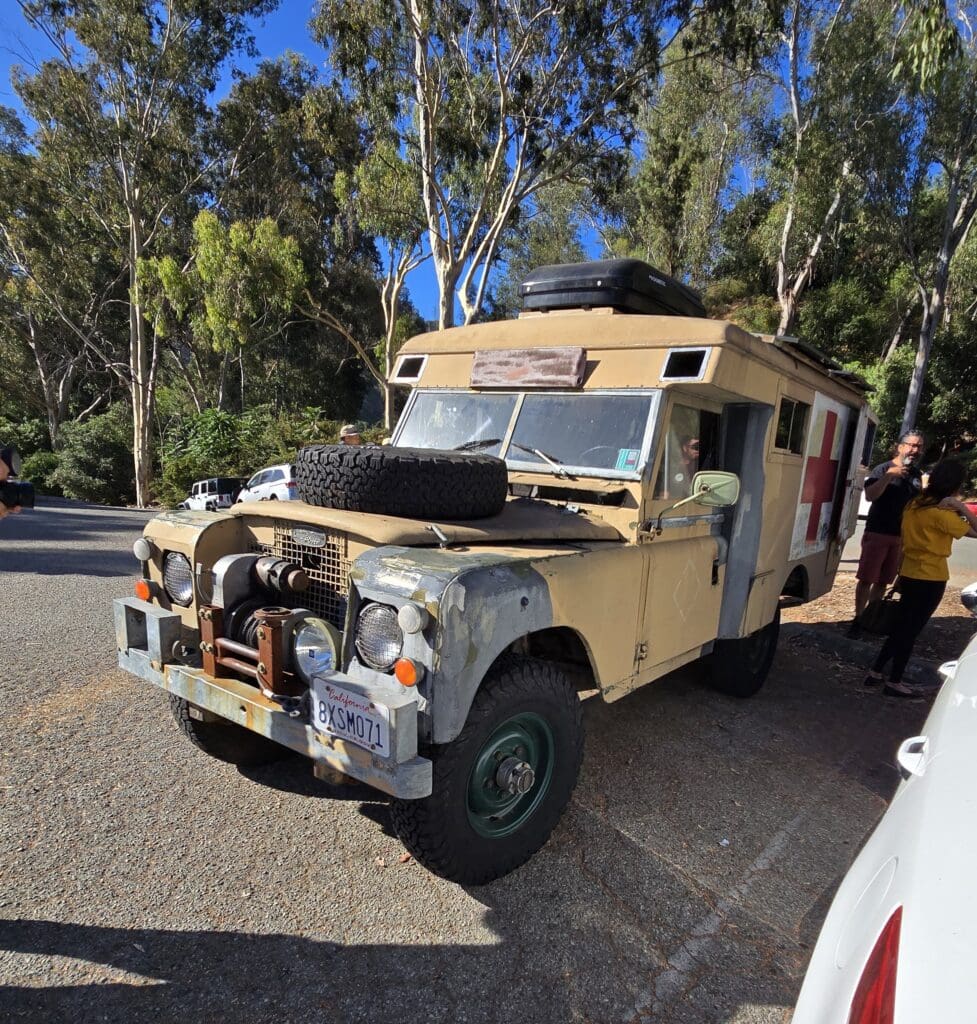 Vintage beige off-road vehicle parked outdoors on a sunny day.