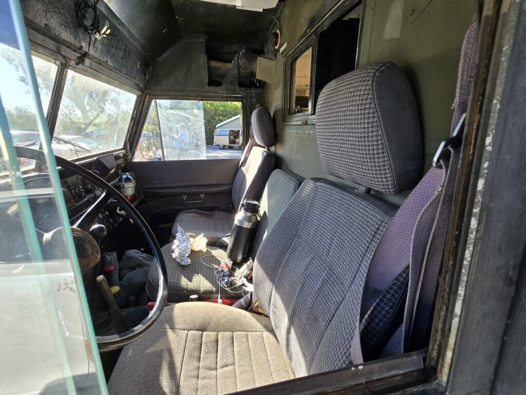 Interior of a rugged off-road vehicle showing front seats and dashboard.