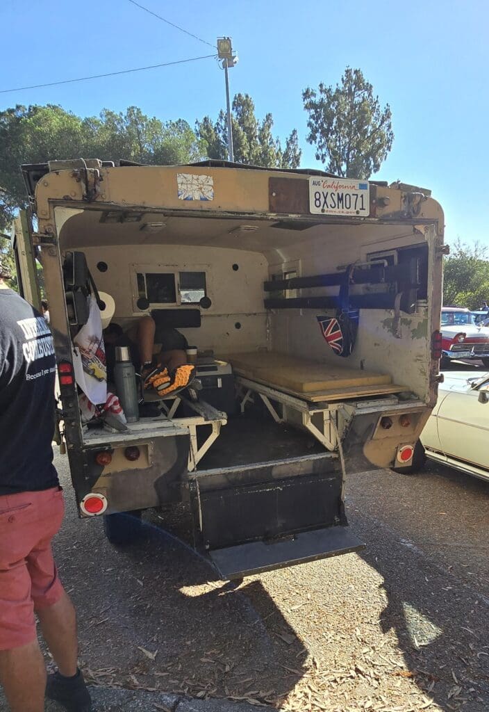 Open utility truck with tools and equipment inside.