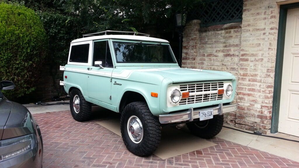 Classic light blue vintage SUV parked on driveway.