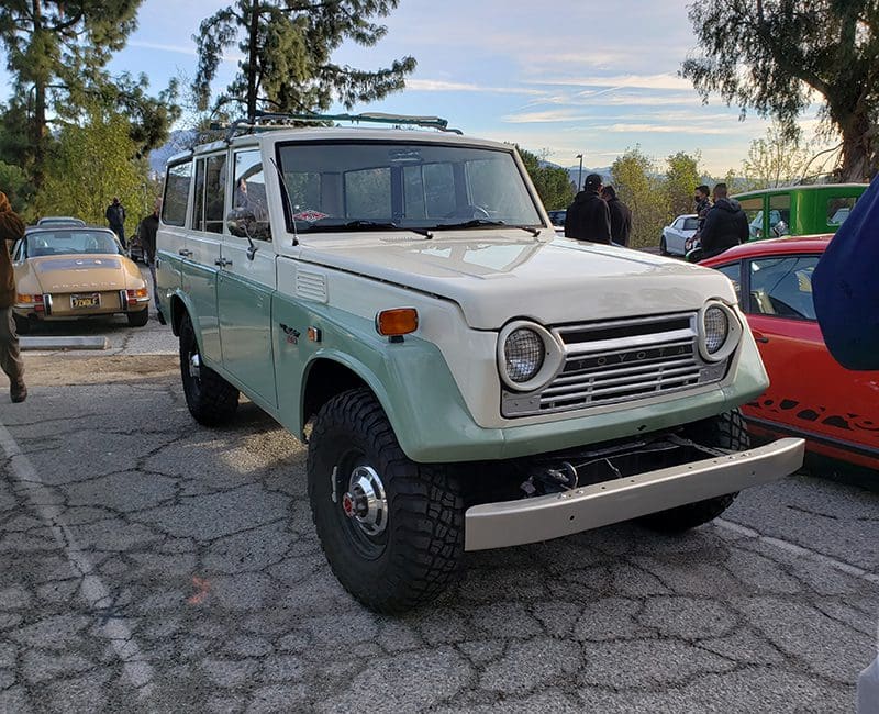 Classic vintage off-road vehicle parked outdoors.