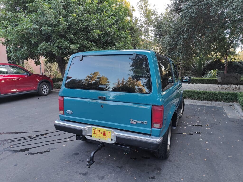 Rear view of a blue Chevrolet SUV parked on a street.