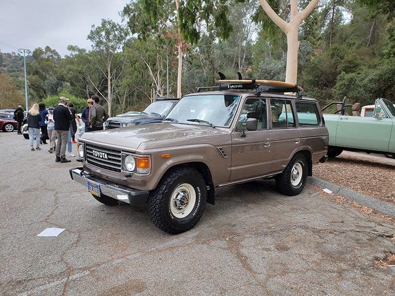 Classic brown off-road SUV parked outdoors with roof rack.