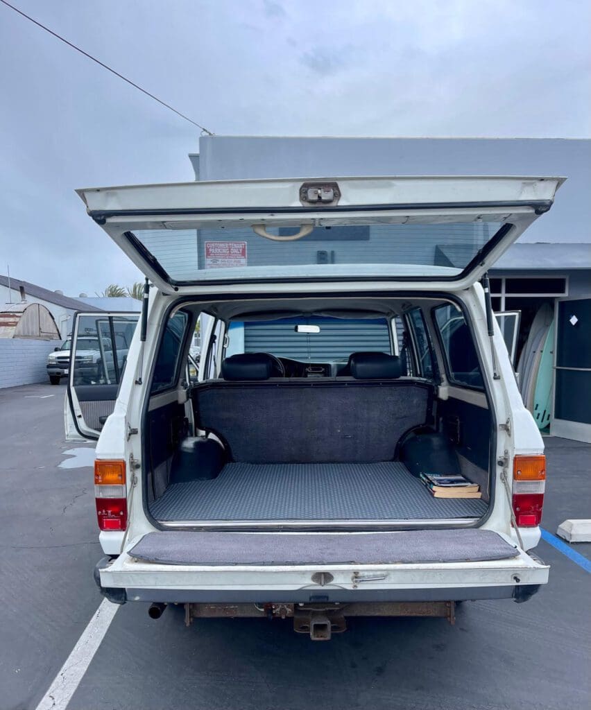 Open rear view of a white SUV showing spacious cargo area.