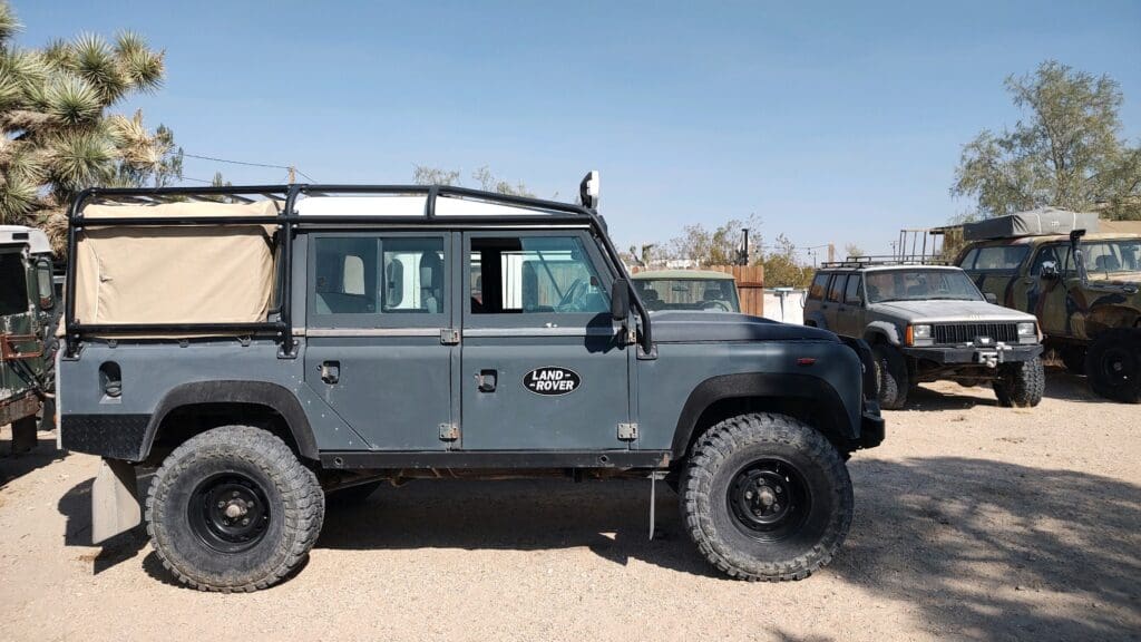 A rugged black off-road vehicle parked outdoors on a sunny day.