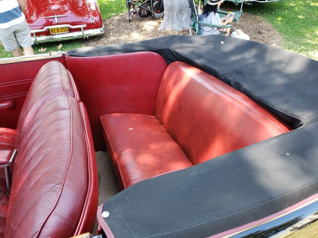 Red leather seats in a vintage convertible car.