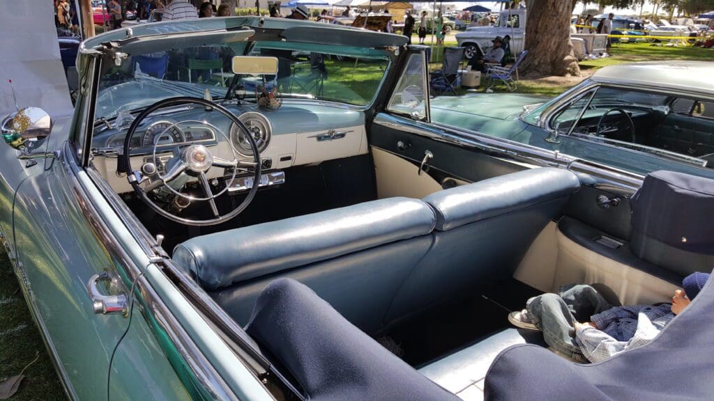 Interior view of a vintage convertible car with classic dashboard and leather seats.