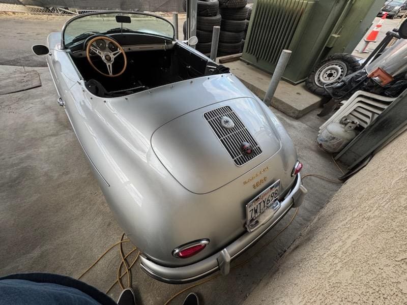 Silver vintage convertible car with classic design details.