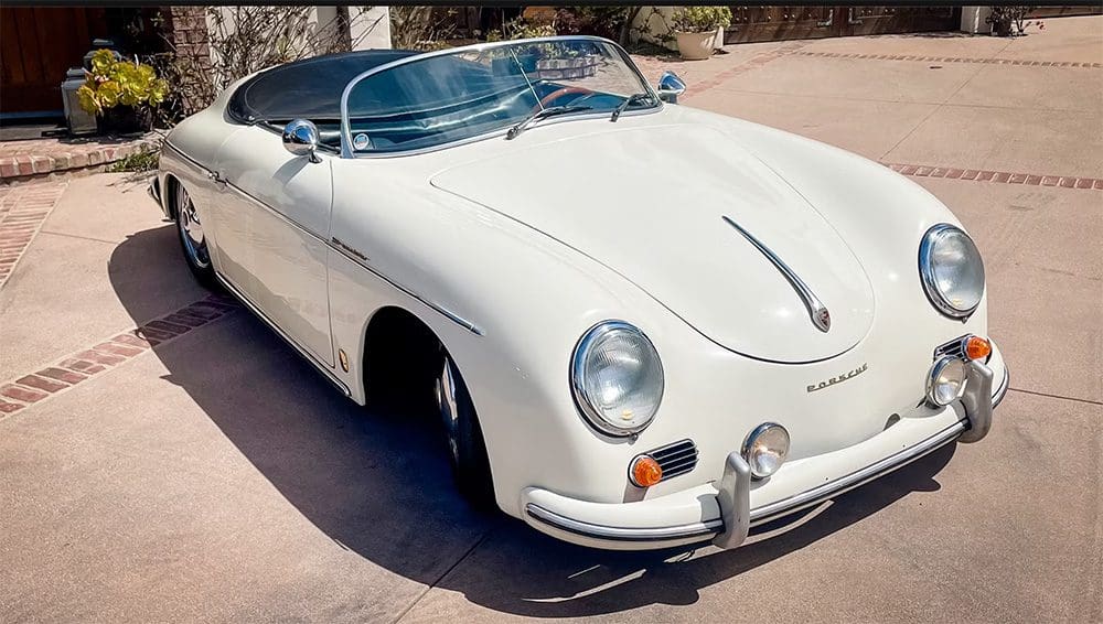 Classic white convertible vintage car parked outdoors.