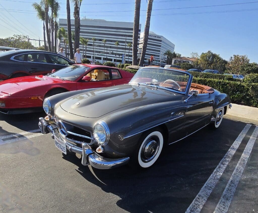 Classic black convertible car parked outdoors under a clear sky.