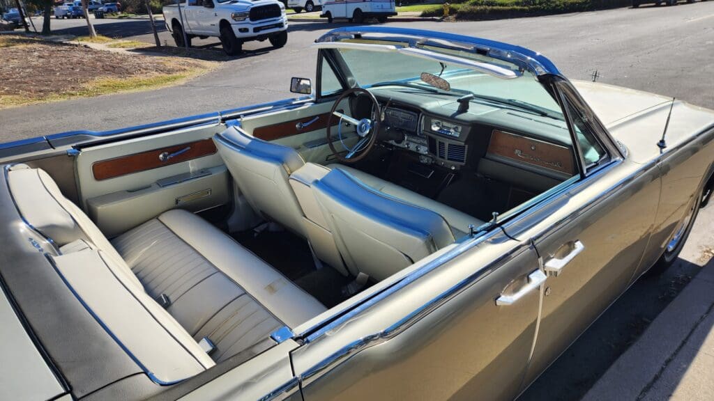 Classic vintage car parked on a sunny suburban street.