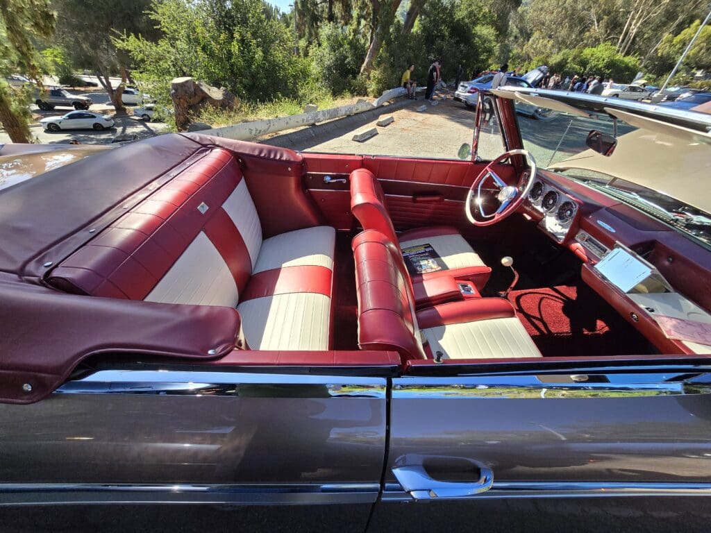 Classic convertible car interior with red and white seats.