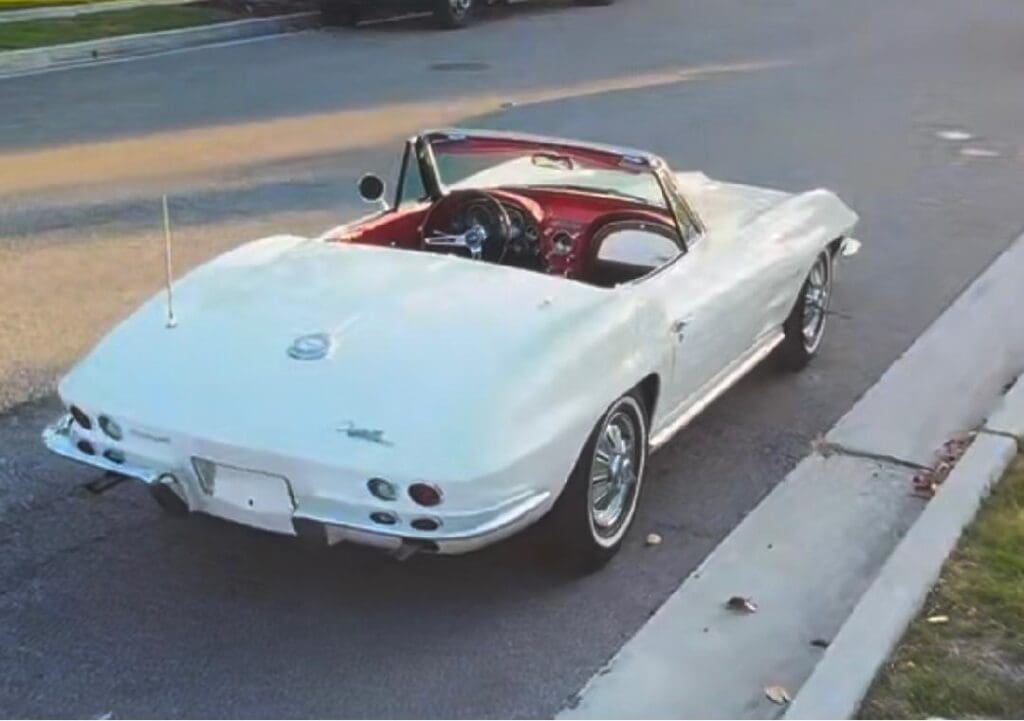 Classic white convertible car parked on a street.