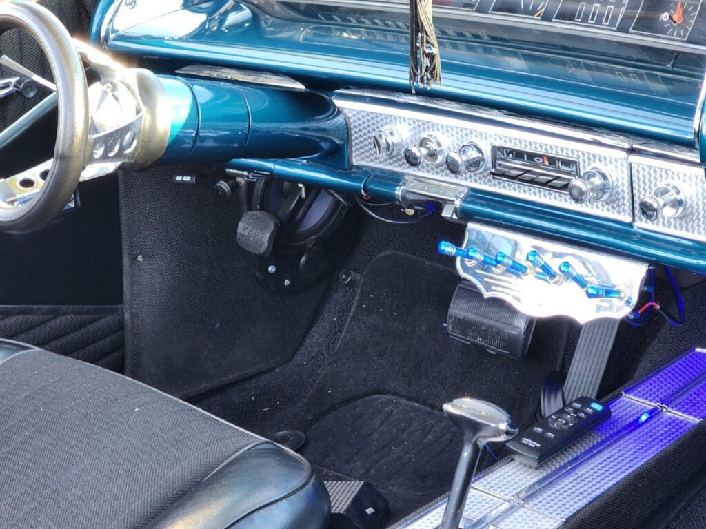 Interior of a vintage car with a classic dashboard and steering wheel.