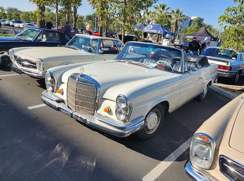 Classic white Mercedes convertible parked at a car show.