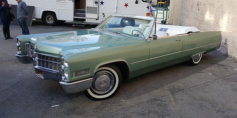 Classic green convertible vintage car with whitewall tires.