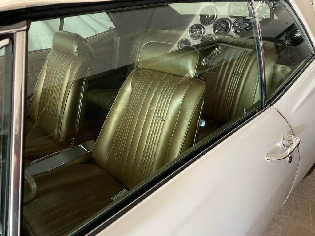 Vintage car interior with classic tan leather seats.
