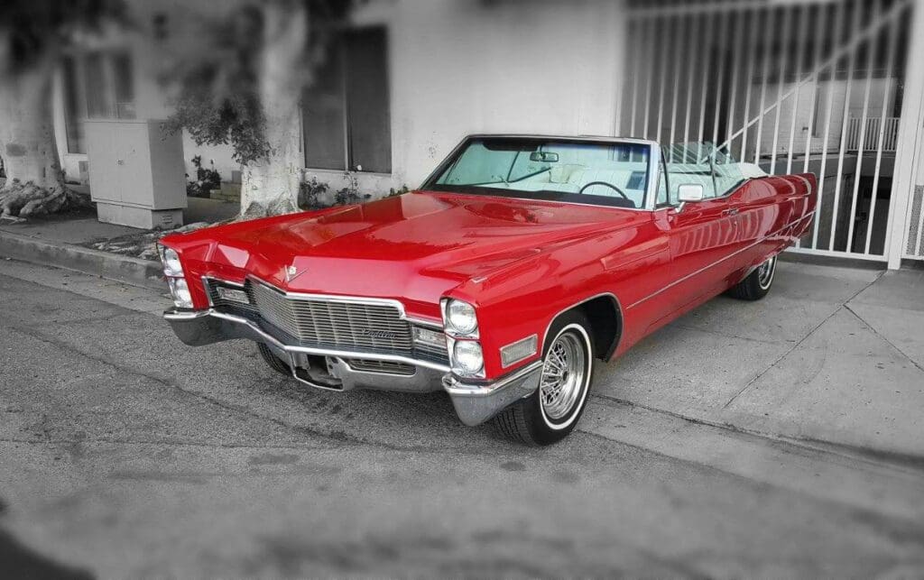 Classic red convertible car parked on a street.