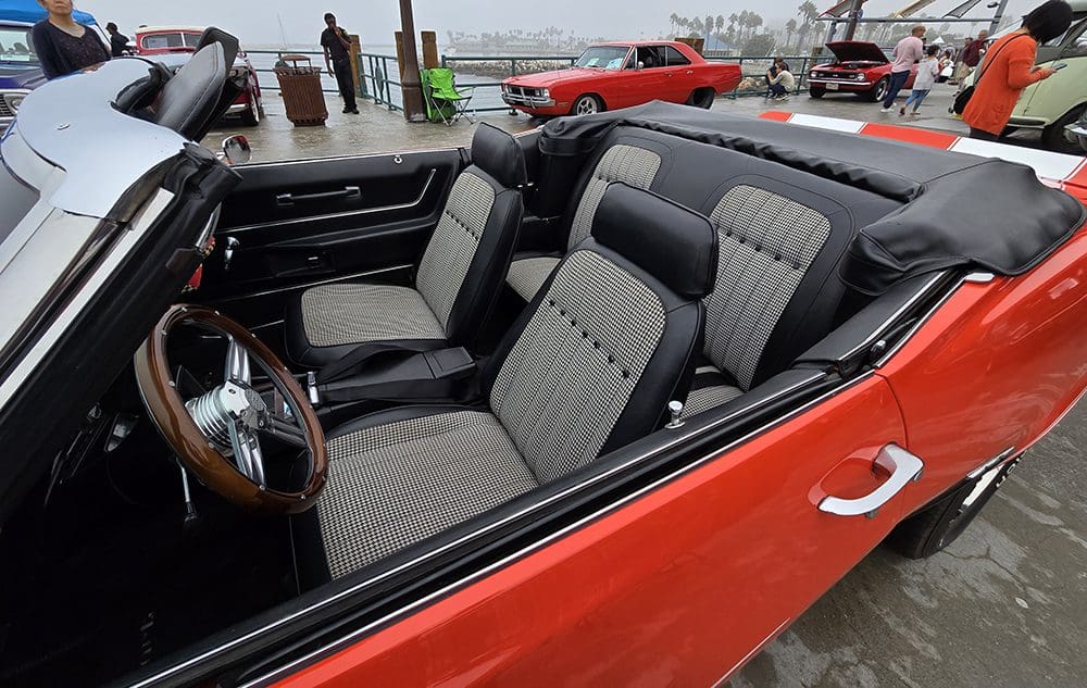 Interior view of a classic convertible car with black and gray seats.