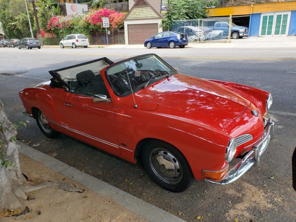 Red vintage convertible car parked on the street.