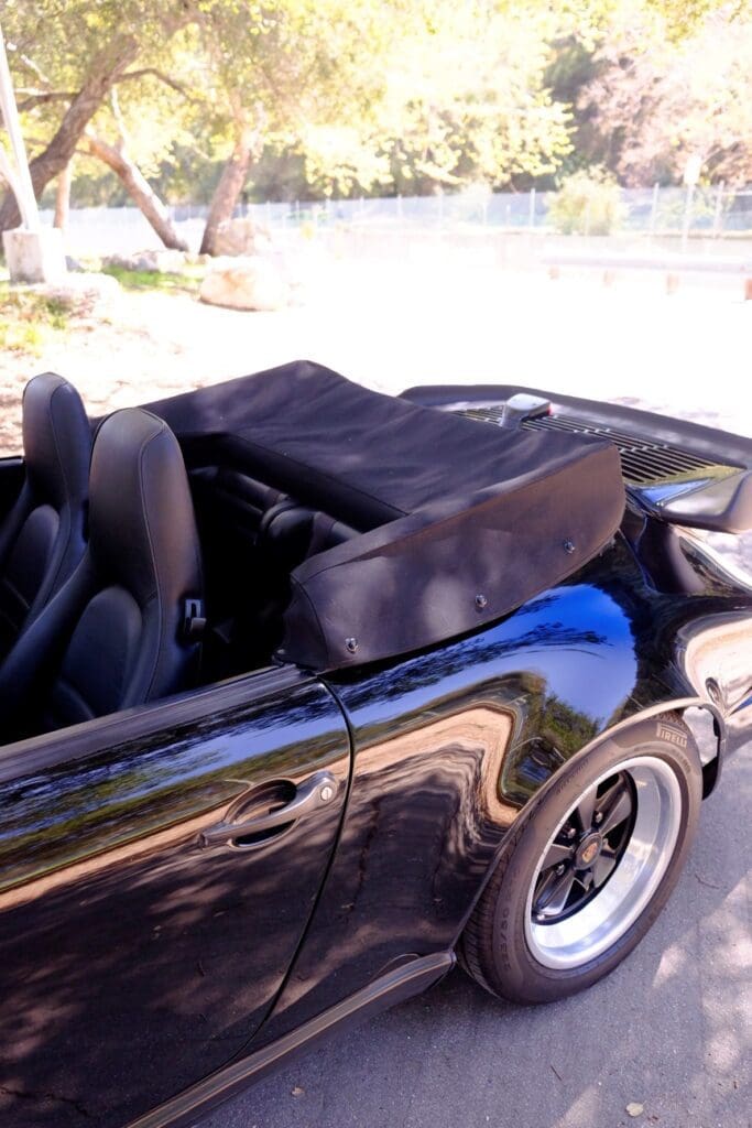 Black convertible sports car with its top down.