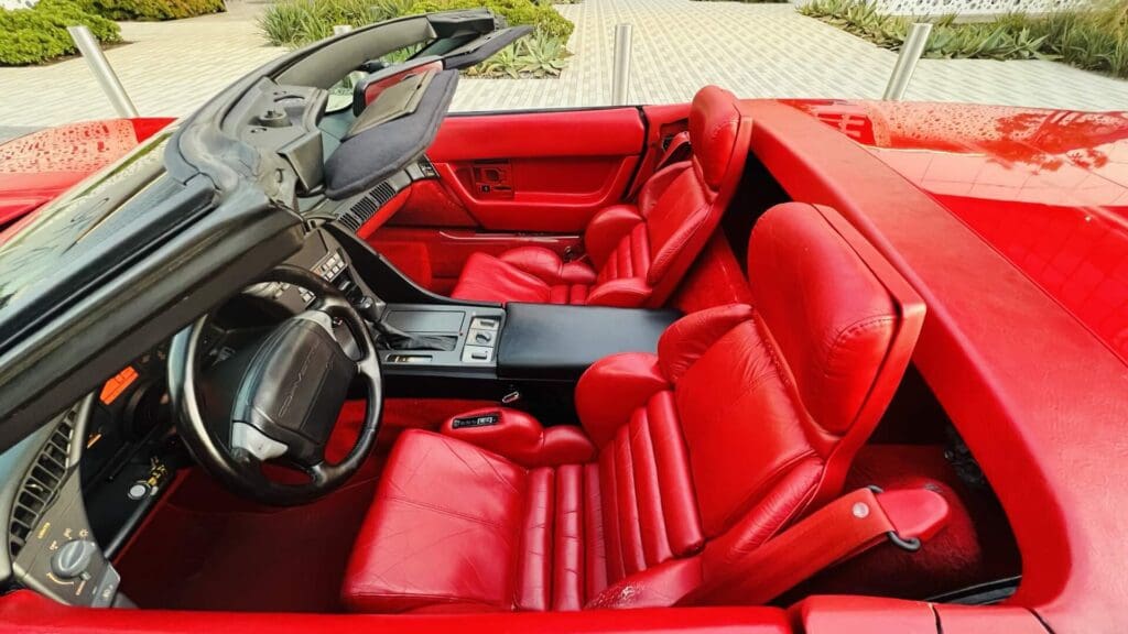 Luxurious red leather interior of a sports car with sleek design.