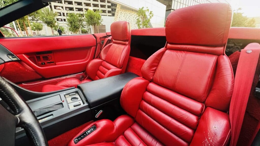 Luxurious red leather seats inside a sports car.