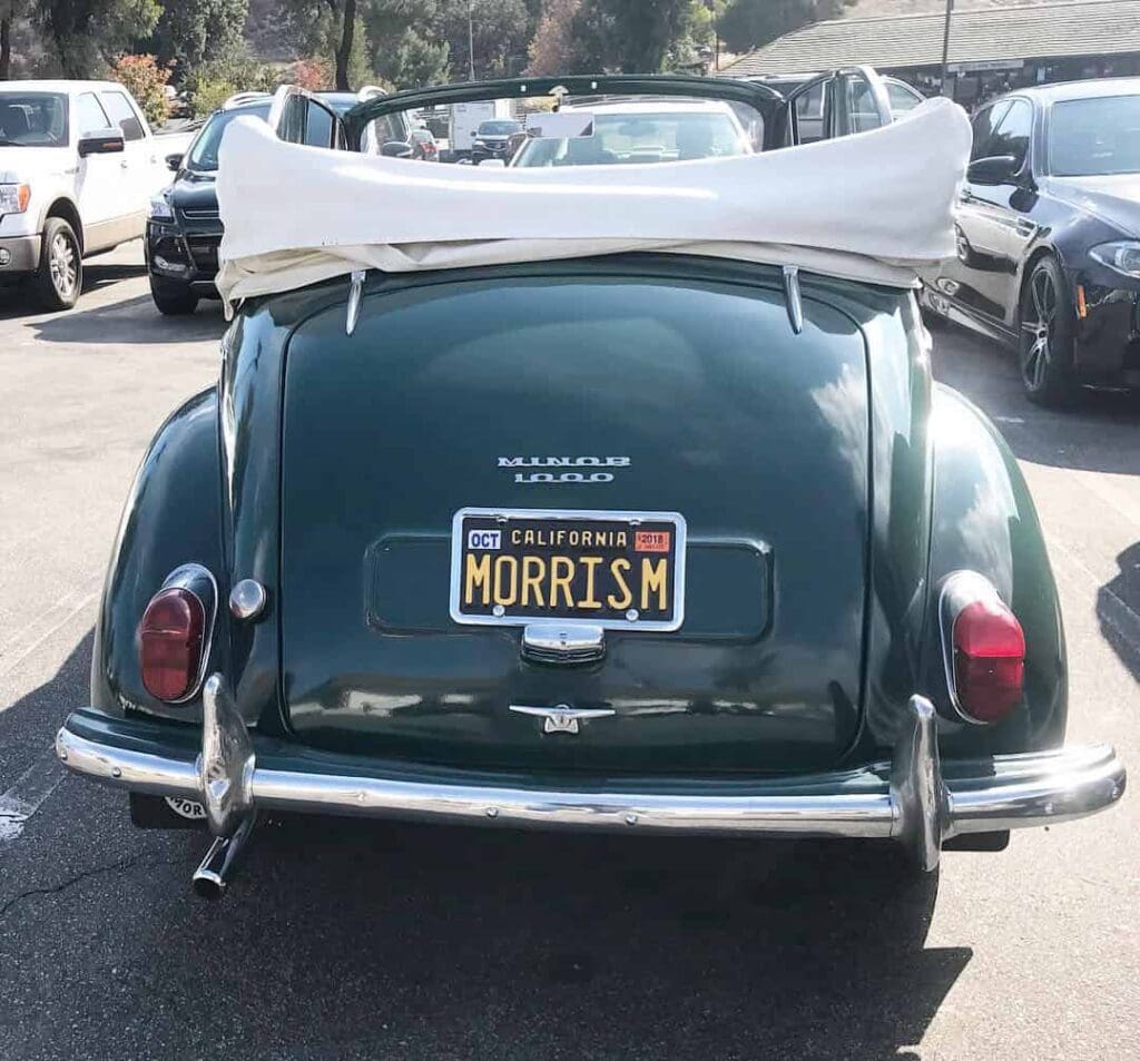 Rear view of a classic Morris convertible car with the top down.
