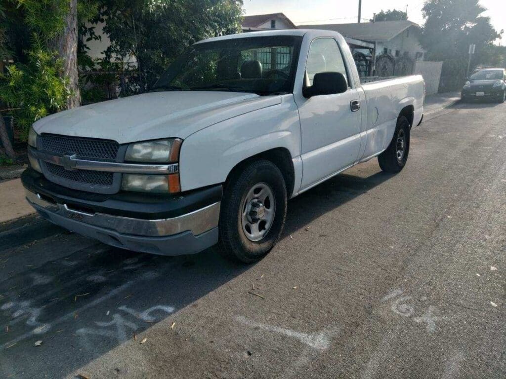 White Chevrolet pickup truck parked on the street.