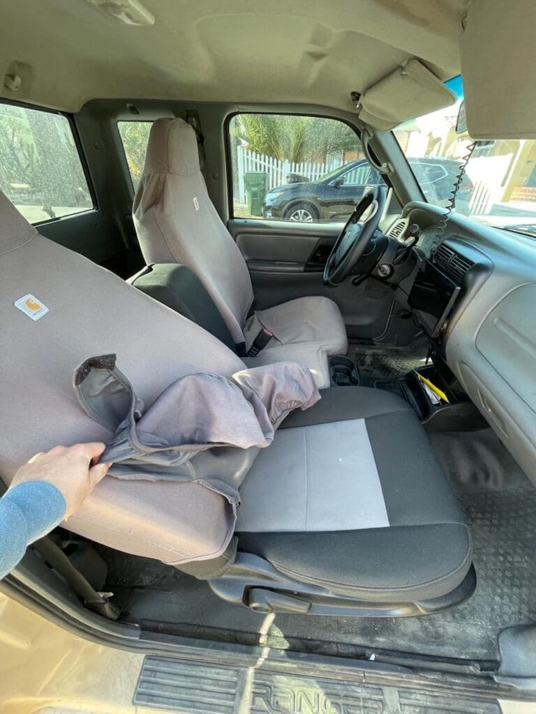 Interior view of a vehicle showing front seats and dashboard.