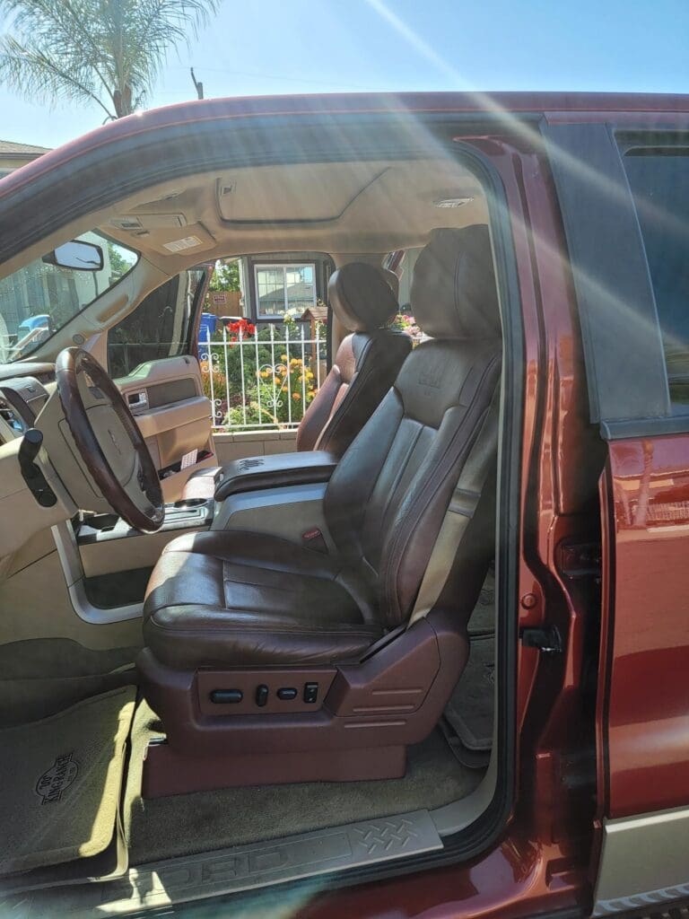 Interior of a car showing front leather seats and dashboard.