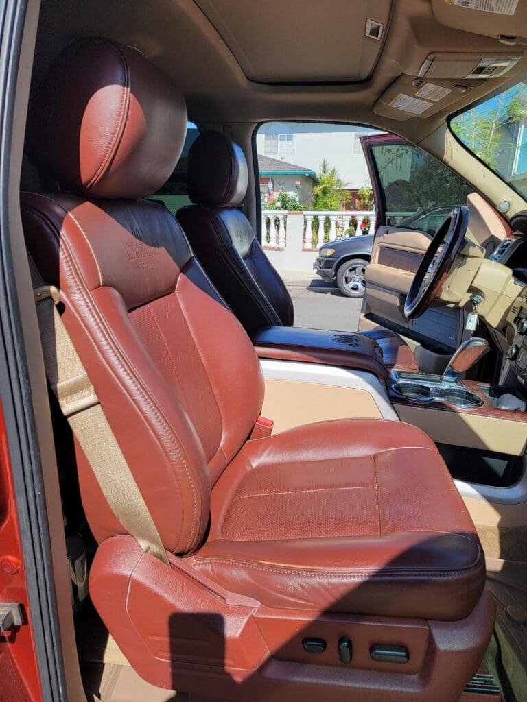 Luxurious tan leather car seats with detailed stitching inside a modern vehicle.