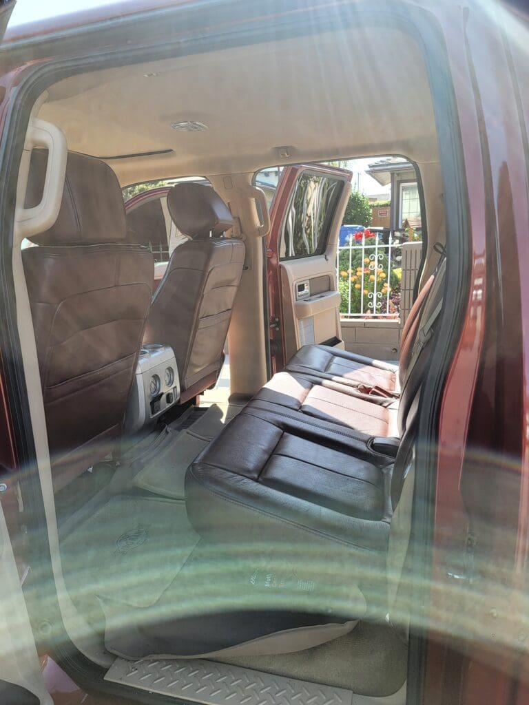 Interior view of a vehicle with folded rear seats and visible front seats.