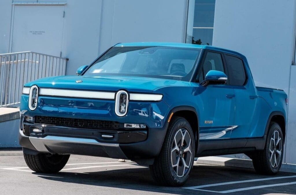 Blue electric SUV parked outdoors on a sunny day.
