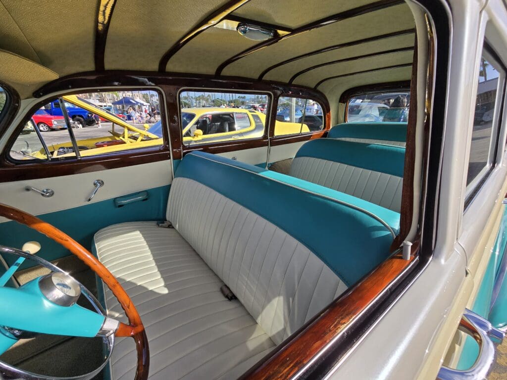 Interior of a classic car showcasing vintage upholstery and styling.