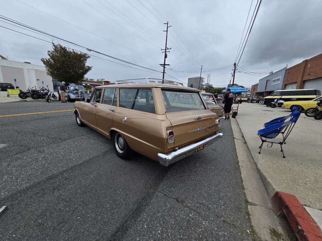 Classic brown station wagon parked on a street under cloudy skies.