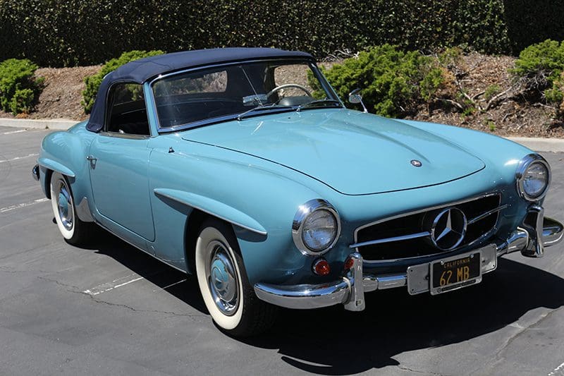Classic blue Mercedes convertible parked outdoors on a sunny day.