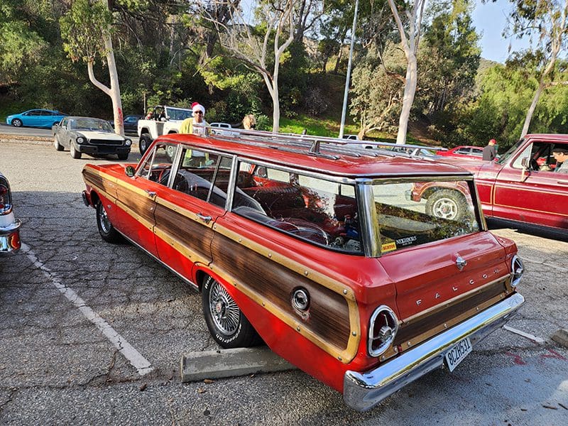 Vintage red and wood-paneled station wagon parked outdoors.