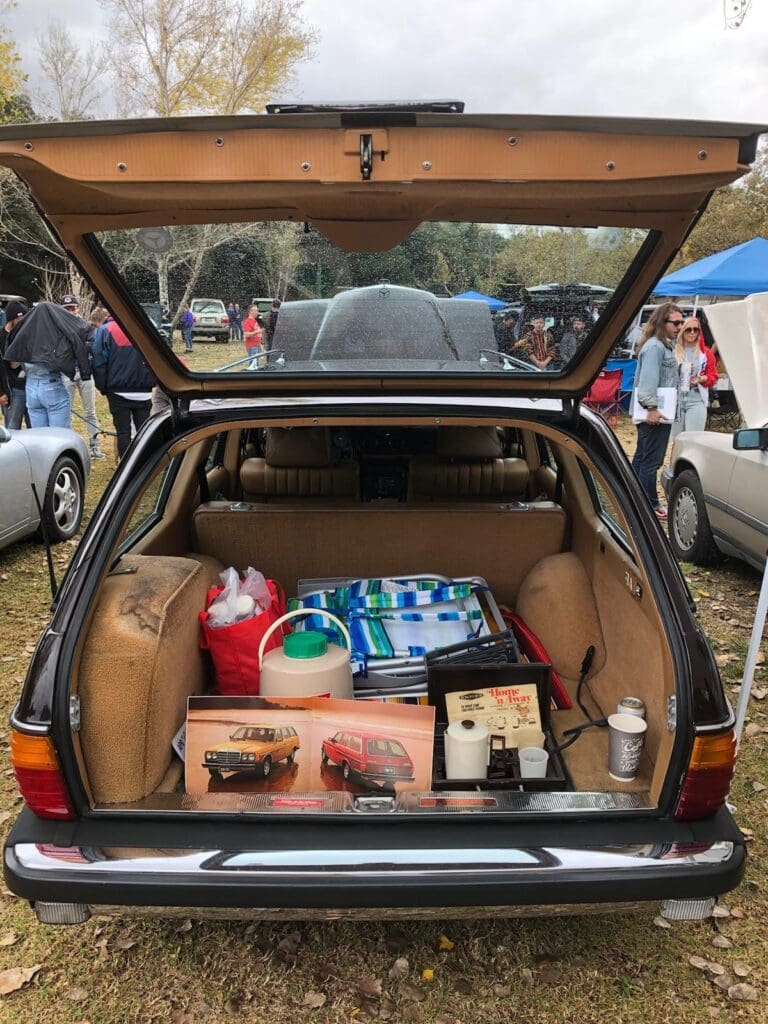 Open car trunk filled with various groceries and supplies.