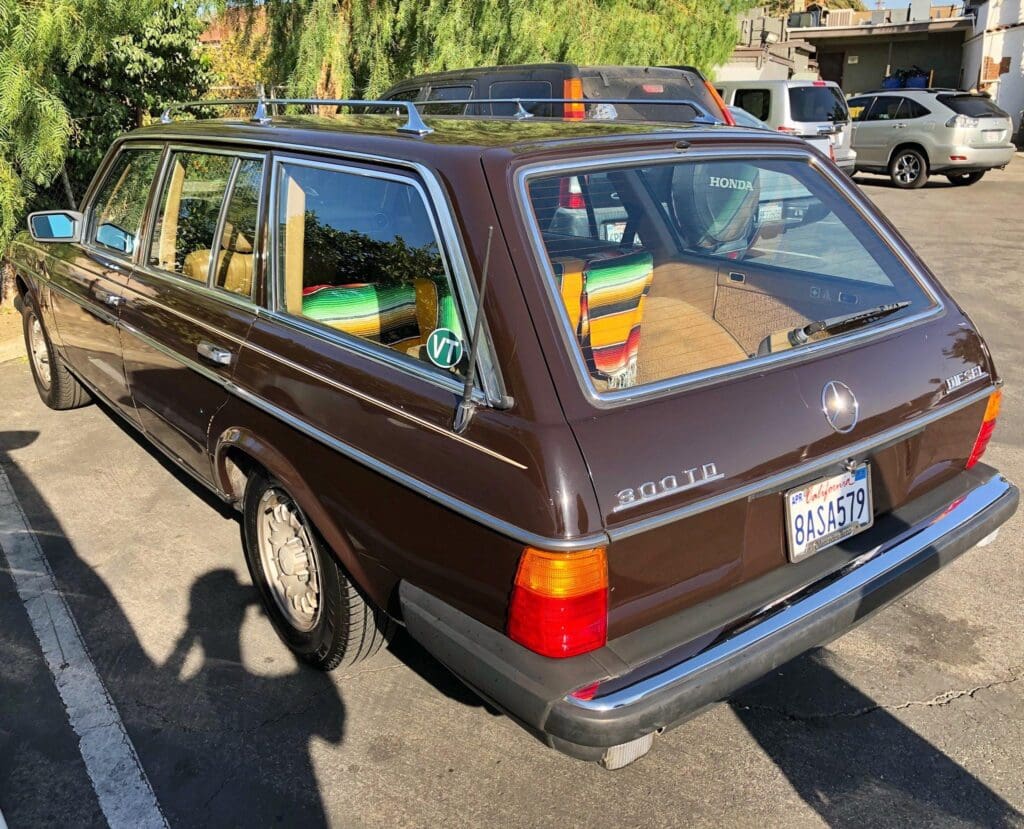 Vintage brown Volvo station wagon parked outdoors on a sunny day.
