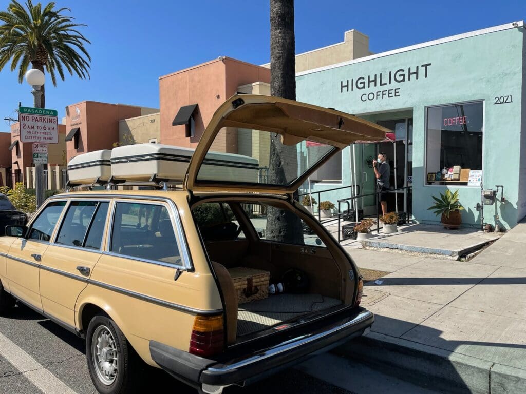 Classic yellow Mercedes-Benz car parked outdoors on a sunny day.