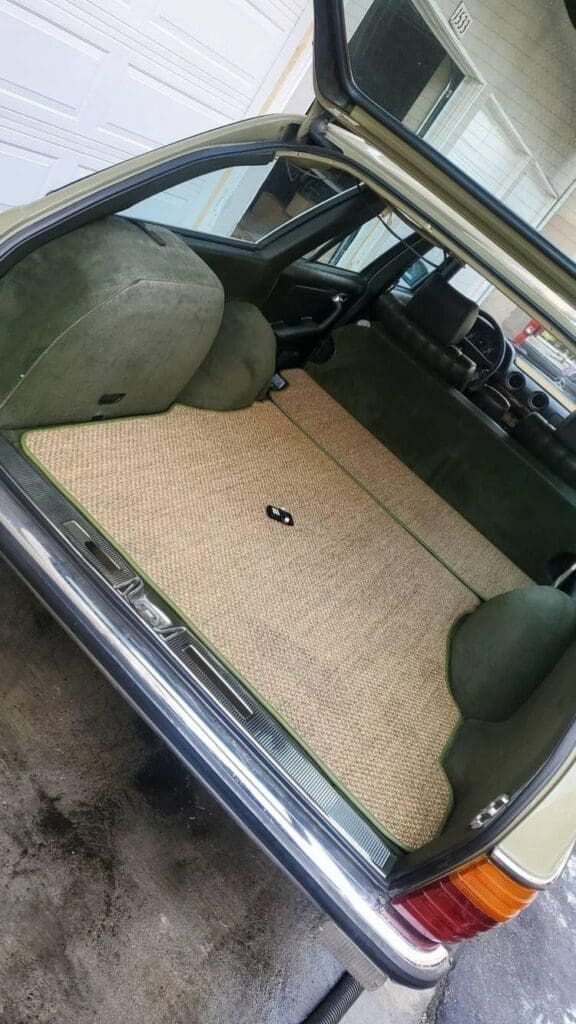Clean beige carpet in a car's interior trunk area.