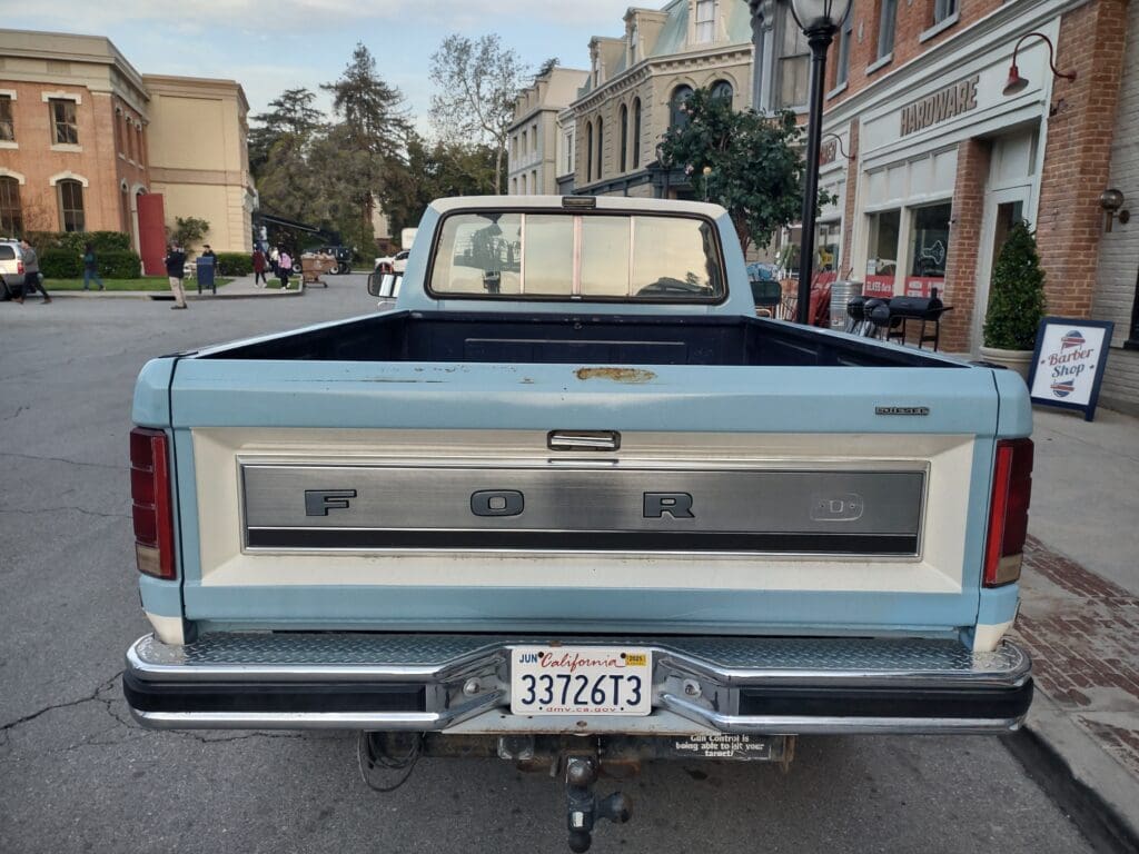 Rear view of a vintage blue Chevrolet pickup truck with a California license plate.