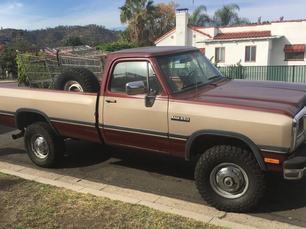 Classic two-tone pickup truck parked on a suburban street.