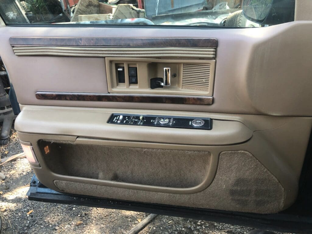 A vintage two-tone station wagon parked outdoors.